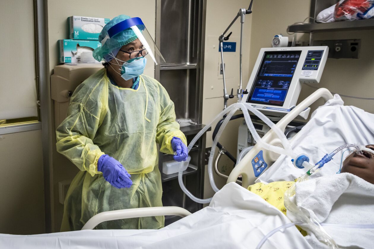 Nurse Alma Abad checks on a patient with COVID-19 in the Intensive Care Unit at Roseland Community Hospital on the Far South Side earlier this month.